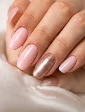 Soft pink glossy manicure with one champagne shimmer nail