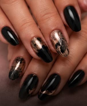 Glossy black nails with bronze and gold foil details
